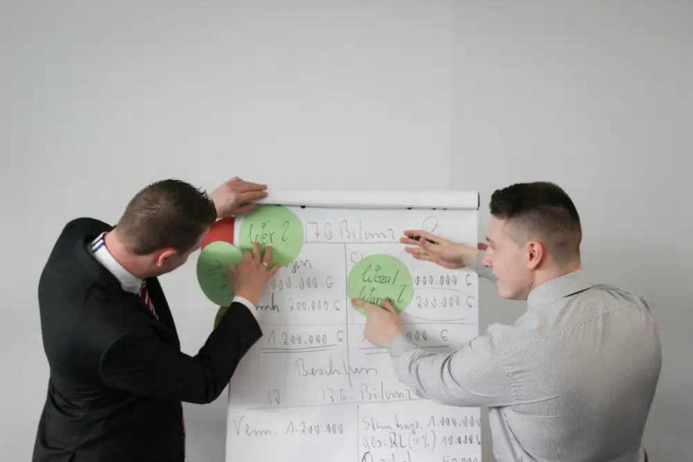 Two men doing presentation visual aide, illustrating developing thoughtful visual concepts